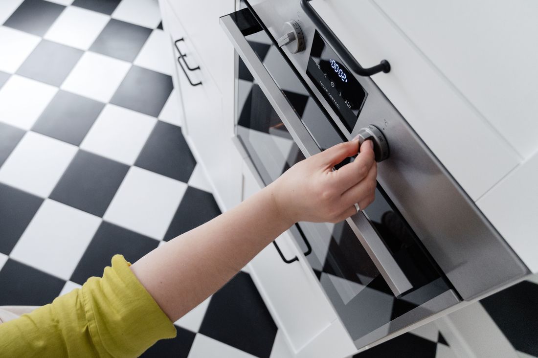 A built-in oven being removed from a kitchen